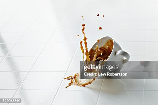 Coffee cup in mid air with coffee spilling Coffee cup in mid air with coffee spilling