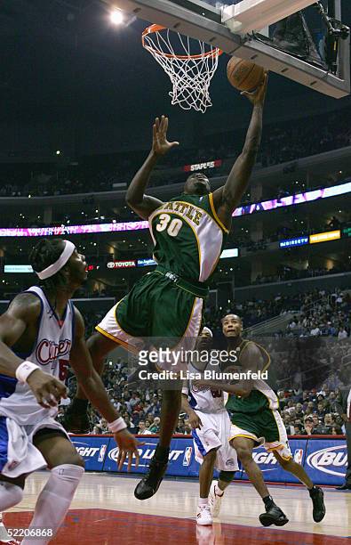 Reggie Evans of the Seattle Sonics lays up a shot against Chris Wilcox of the Los Angeles Clippers during the Clippers home opener at Staples Center...