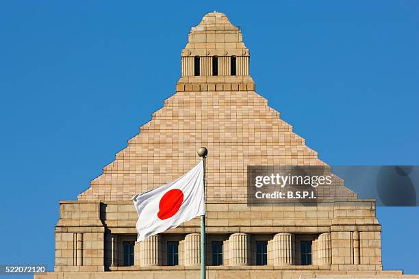 front view of granite tower dome of japan's national diet building, in the nagatacho district of tokyo - japanese flag stock pictures, royalty-free photos & images