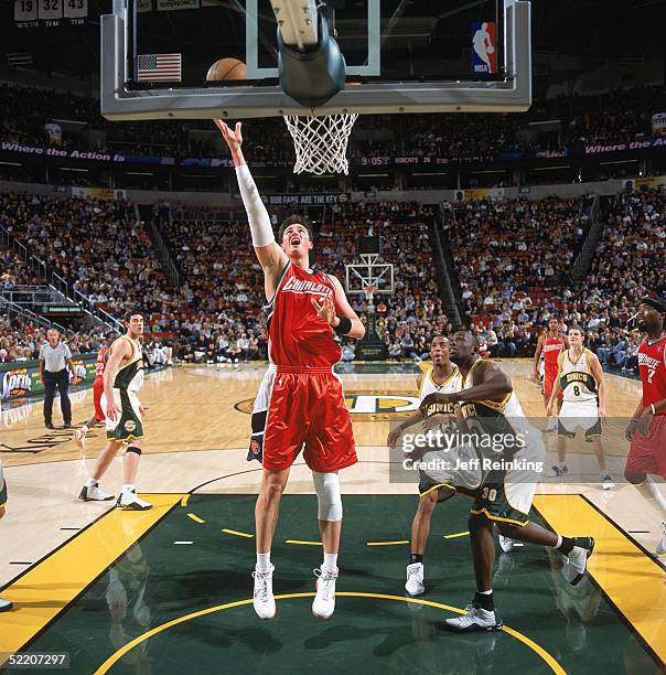 Primoz Brezec of the Charlotte Bobcats shoots a layup past Reggie Evans of the Seattle Sonics during a game at Key Arena on February 5, 2005 in...