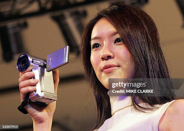 Model takes to the catwalk to display the DCR-PC1000/E handheld video camera during a press launch in Hong Kong, 17 February 2005. Sony Corp in Hong...