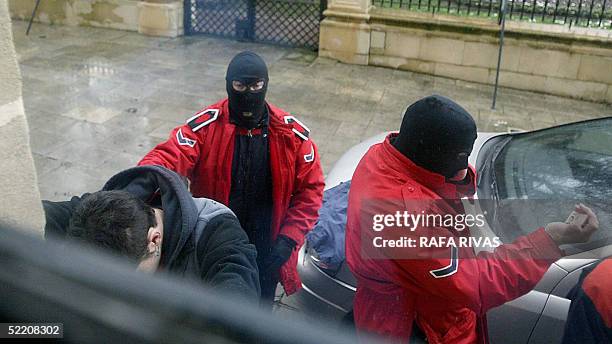 An ertzaina detains and another one identifies one of the seven unidentified people who interrupted the Basque Parliament session 17 February 2005 in...