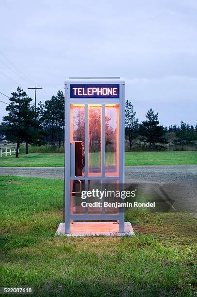 telephone booth by road - telefonzelle stock-fotos und bilder