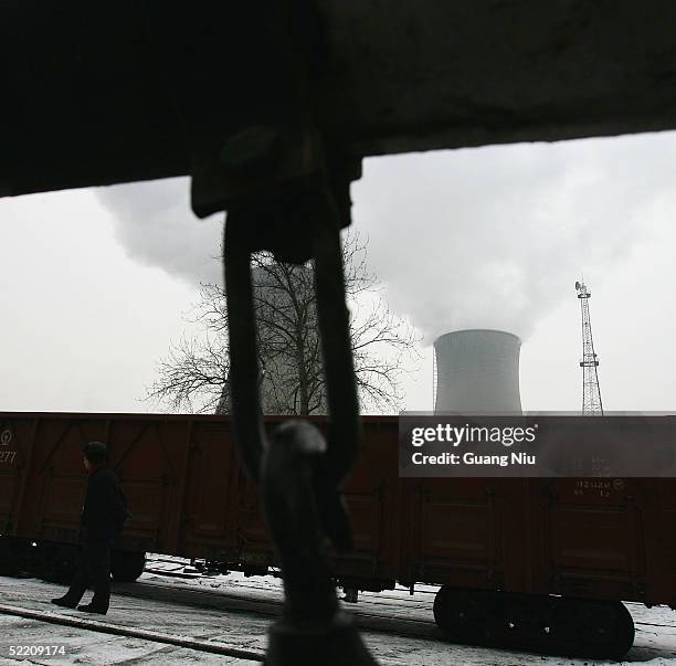 Gas emissions belch from a giant chimney of a power station on February 17, 2005 in Beijing, China. China, the world's second biggest greenhouse gas...