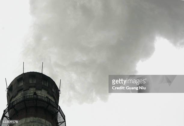 Gas emissions belch from a giant chimney of a power station on February 17, 2005 in Beijing, China. China, the world's second biggest greenhouse gas...