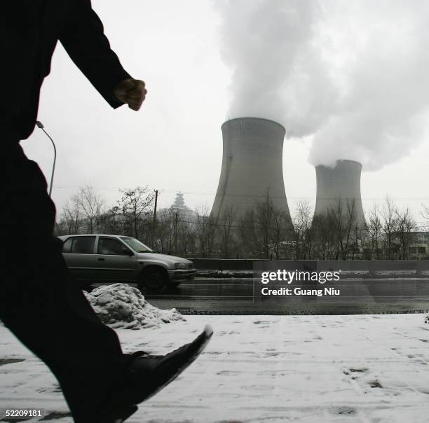 Gas emissions belch from a giant chimney of a power station on February 17, 2005 in Beijing, China. China, the world's second biggest greenhouse gas...