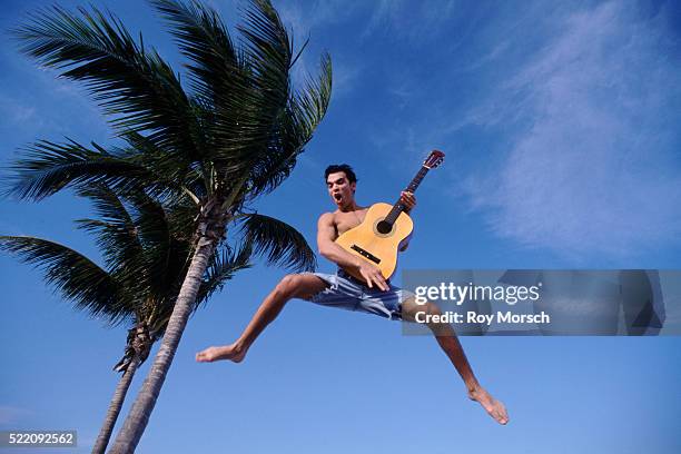 man jumping in air with guitar - air guitar stockfoto's en -beelden