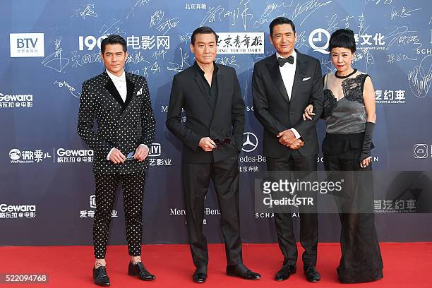 This photo taken on April 16, 2016 shows Hong Kong actors Aaron Kwok, Tony Leung Ka Fai, Chow Yun Fat and his wife Jasmine Tan posing on the red...