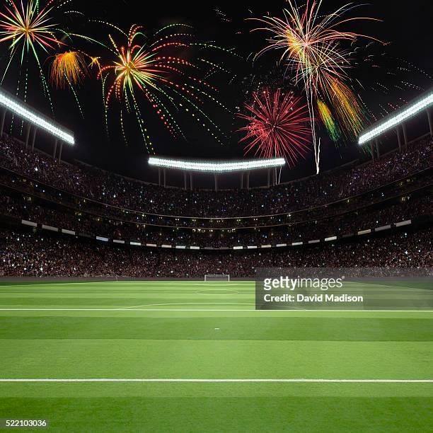 view of soccer field, goal and stadium with fireworks in sky - international soccer event 個照片及圖片檔