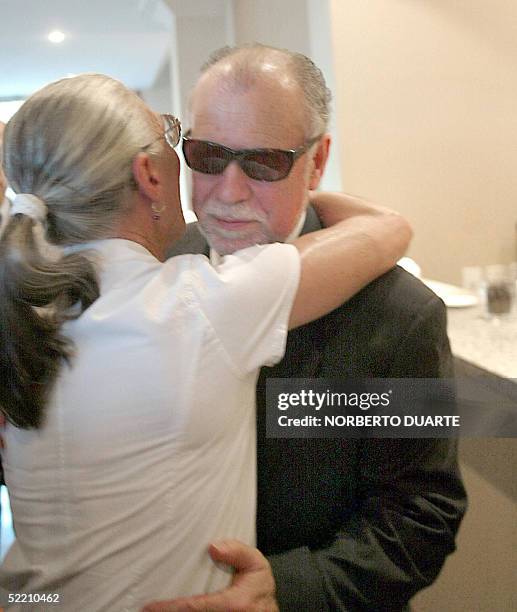 Paraguayan former President Raul Cubas is hugged by a woman at the wake of his daughter Cecilia Cubas, in Asuncion, 17 February 2005. Five months...