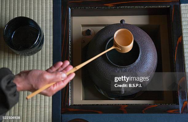 an interior view shows a tea master preparing the tea ceremony in the tearoom of a residence near shugakuin in the sakyo district of northeast kyoto, japan. - cérémonie du thé photos et images de collection