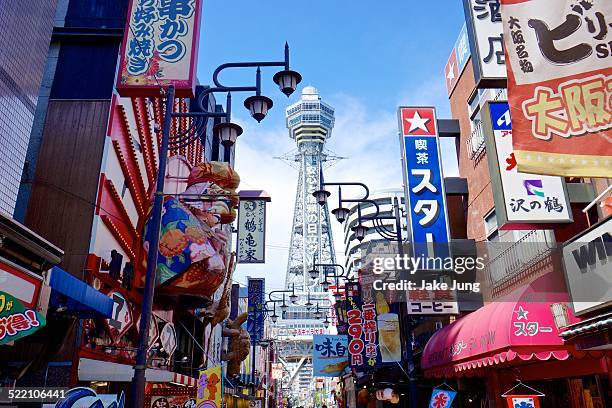 color signs and tsutenkaku tower in south osaka - osaka prefecture stock-fotos und bilder