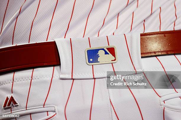 The MLB logo is seen on the belt loop of a Philadelphia Phillies player during a game against the Washington Nationals at Citizens Bank Park on April...