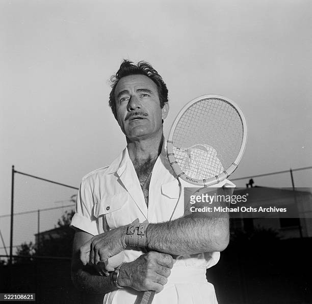 Actor Gilbert Roland plays tennis during a portrait session at home in Los Angeles,CA.