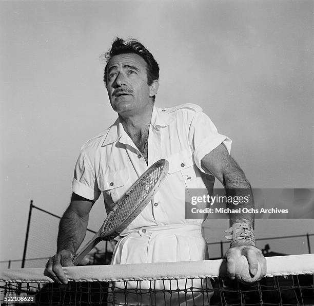 Actor Gilbert Roland plays tennis during a portrait session at home in Los Angeles,CA.