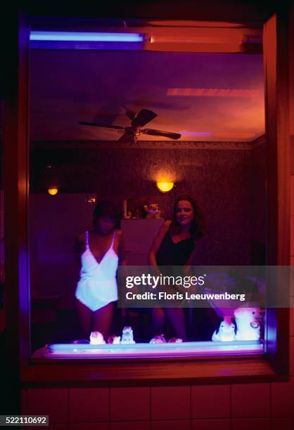 prostitutes in amsterdam's red light district - amsterdam red light district stock pictures, royalty-free photos & images
