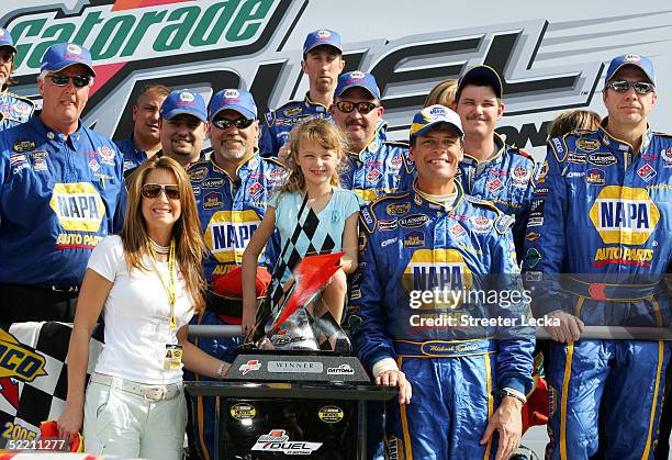 Michael Waltrip stands with his wife Buffy, daughter Margaret and members of the victorious DEI NAPA Auto Parts Chevrolet after winning the first...