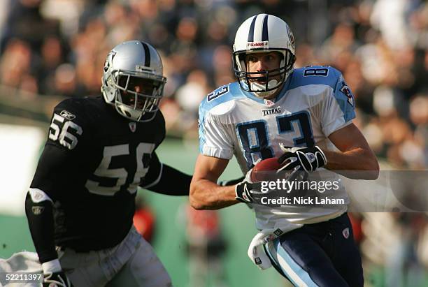 Wide receiver Drew Bennett of the Tennessee Titans runs upfield from linebacker Travian Smith of the Oakland Raiders on December 19, 2004 at Network...