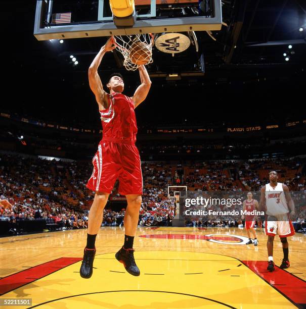 Yao Ming of the Houston Rockets dunks during the game against the Miami Heat at American Airlines Arena on January 30, 2005 in Miami, Florida. The...