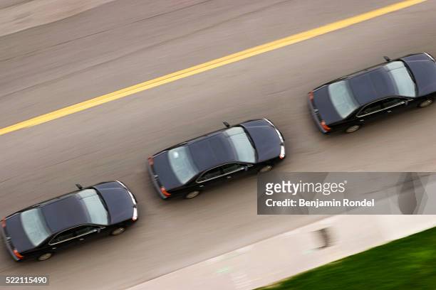 three cars driving down the road - entourage stock pictures, royalty-free photos & images