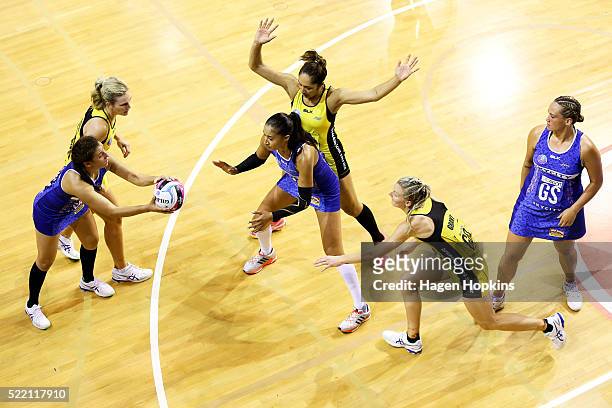 Nadia Loveday of the Mystics attempts to pass to teammate Maria Tutaia while under pressure from Katrina Grant and Phoenix Karaka of the Pulse during...