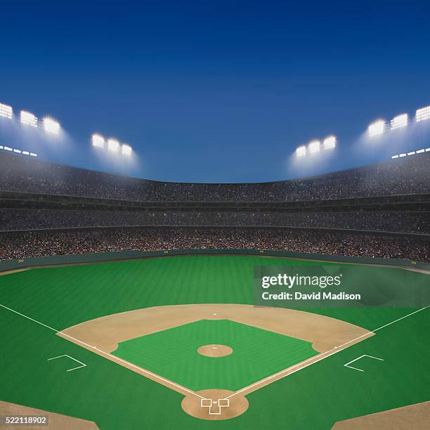 baseball field and stadium at twilight. - baseball crowd stock-fotos und bilder