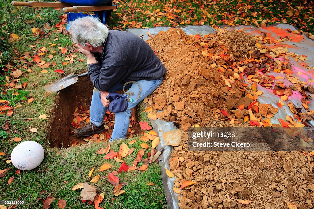 Dog owner finishing his dog grave