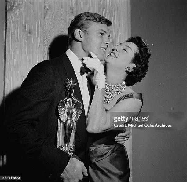Actress Rosalind Russell gives actor Tab Hunter the Audie Award in Los Angeles,CA.