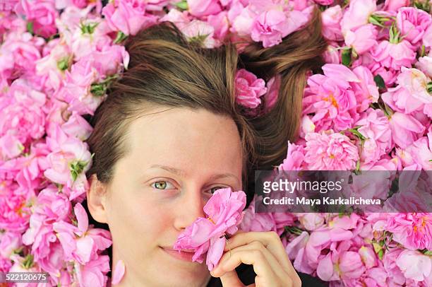 portrait of beautiful young woman in bed of roses - bulgarians stock pictures, royalty-free photos & images