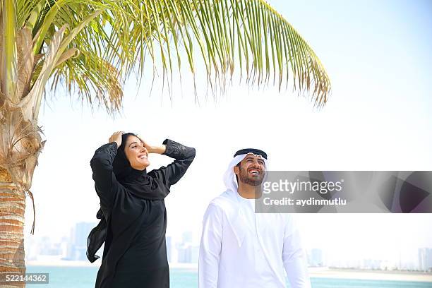 happy arab couple - muslim woman beach stock pictures, royalty-free photos & images
