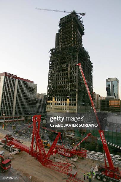 Construction cranes prepare the demolition of the Windsor building in the business district of Madrid ,18 February 2004. The 106-metre high building...