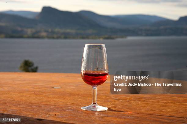 glass of rose wine overlooking okanagan lake - okanagan valley stock-fotos und bilder