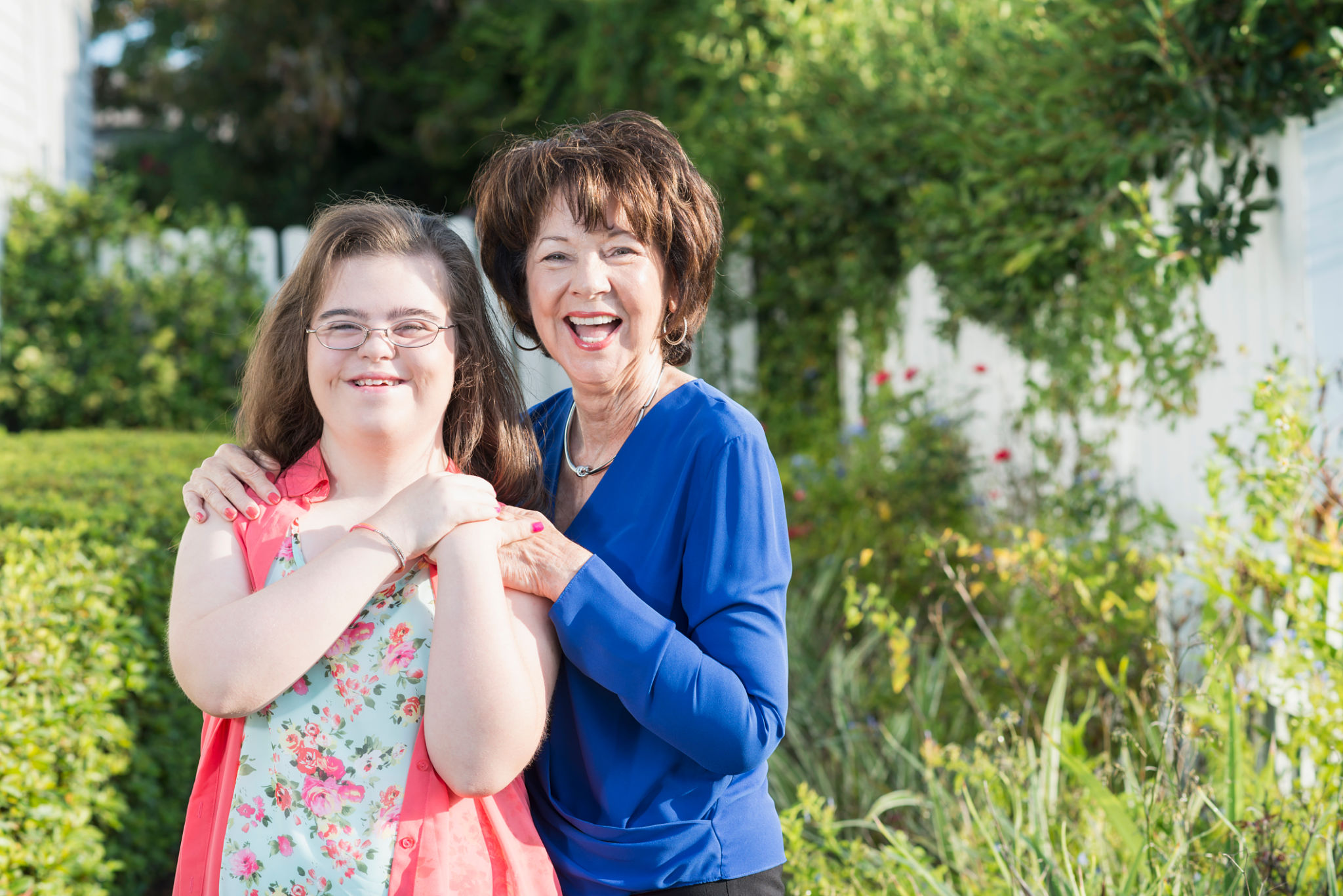 Teenage girl with downs syndrome, grandmother outdoors Teenage girl with downs syndrome, grandmother outdoors
