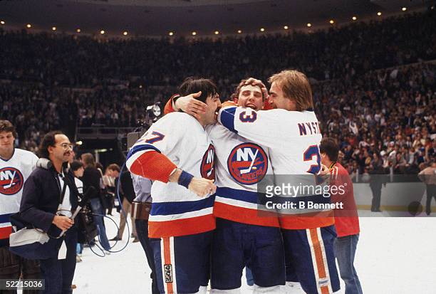 Brent Sutter of the New York Islanders, is surrounded by teammates John Tonelli and Bob Nystrom after the Islanders won the 1982-83 Stanley Cup...