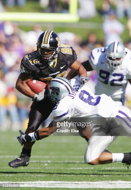 Tailback Marcus Woods of the University of Missouri Tigers is tackled by defensive back Bret Jones of the Kansas State University Wildcats on...