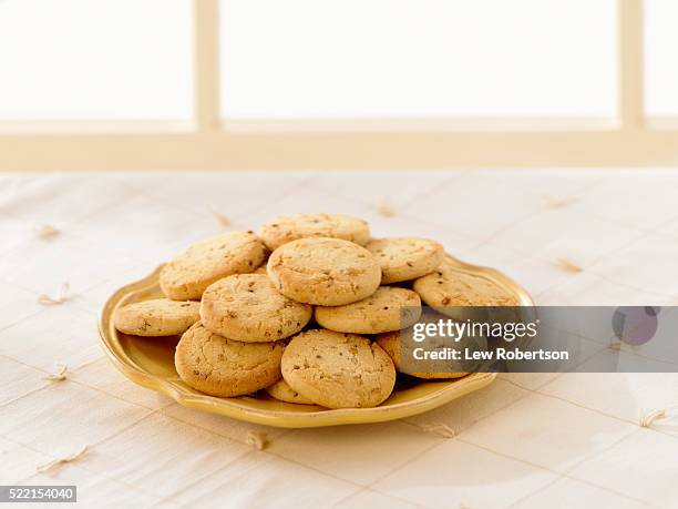 plate of shortbread pecan cookies - shortbread stock pictures, royalty-free photos & images