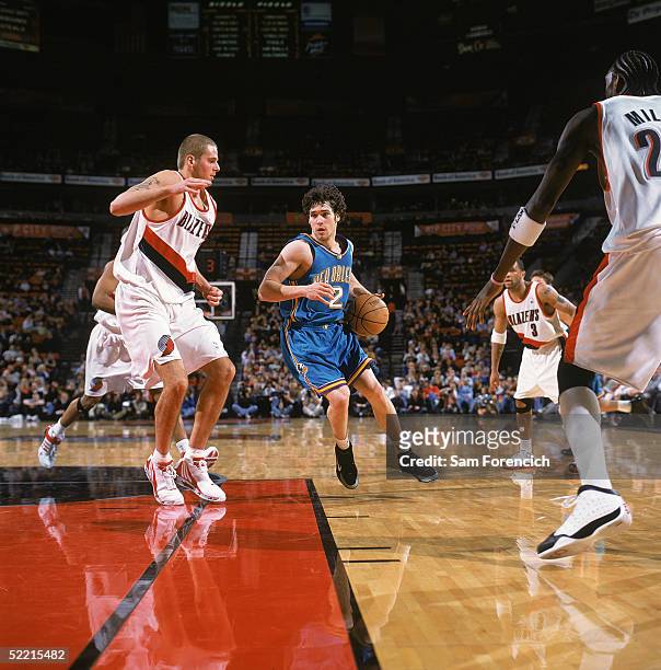 Dan Dickau of the New Orleans Hornets moves the ball against Joel Przybilla of the Portland Trail Blazers during the game at The Rose Garden on...