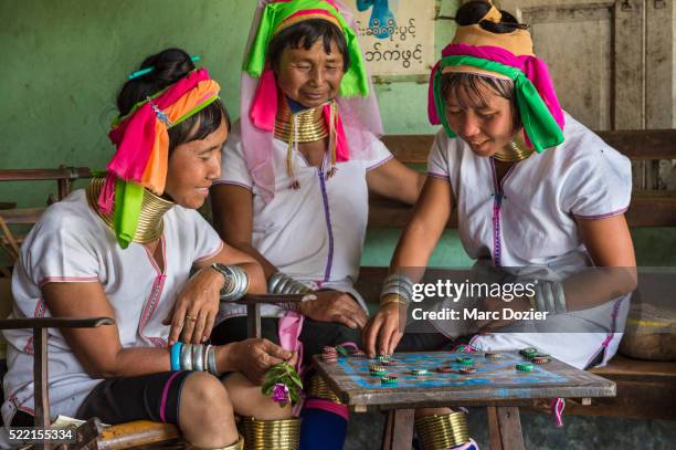 giraffe women playing - padaung tribe stock pictures, royalty-free photos & images