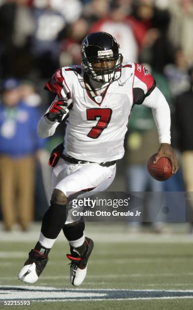 Quarterback Michael Vick of the Atlanta Falcons scrambles with the ball against the Seattle Seahawks at Qwest Field on January 2, 2005 in Seattle,...