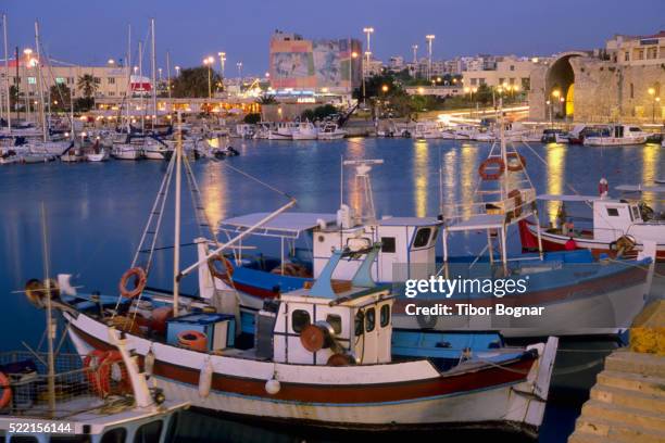 boats in a harbor in greece at dusk - herakleion stock pictures, royalty-free photos & images