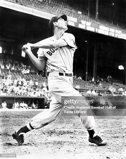 Ted Williams of the Boston Red Sox swings during a game. Teddy Samuel Williams played for the Red Sox from 1939-1960.