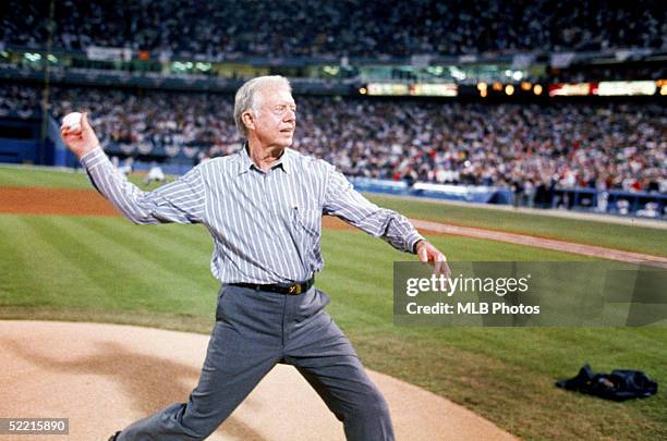 Former President Jimmy Carter throws out the ceremonial first pitch before Game One of the 1992 World Series between the Atlanta Braves and the...