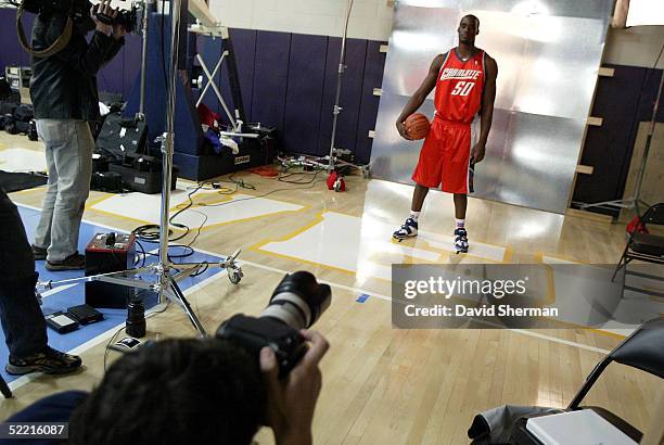 Emeka Okafor of the Rookie Team poses as NBA photographer Tim DeFrisco takes his portrait prior to the got milk? Rookie Challenge during 2005 NBA...