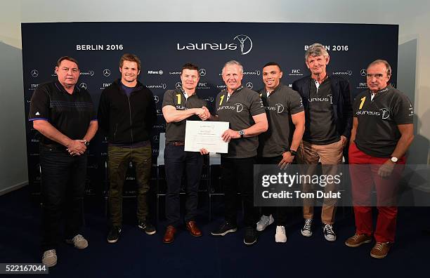 New Laureus World Sports Academy member Brian O'Driscoll shakes the hand of Laureus World Sports Academy member Sean Fitzpatrick as Steve Hansen, All...