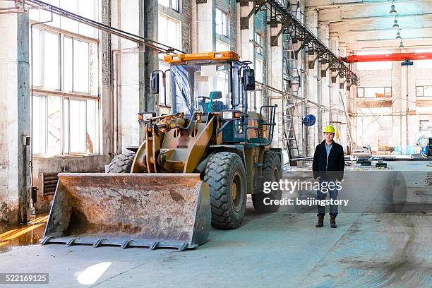 worker and bulldozer - bulldozer stock pictures, royalty-free photos & images