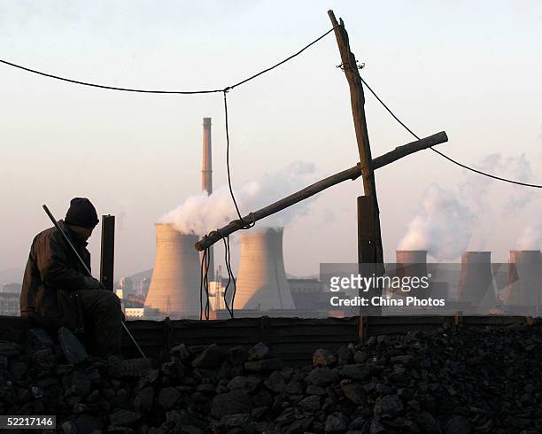 Miner sits near the Sunjiawan Coal Mine accident site on February 18, 2005 in Fuxin of Liaoning Province, northeast China. The death toll from a gas...