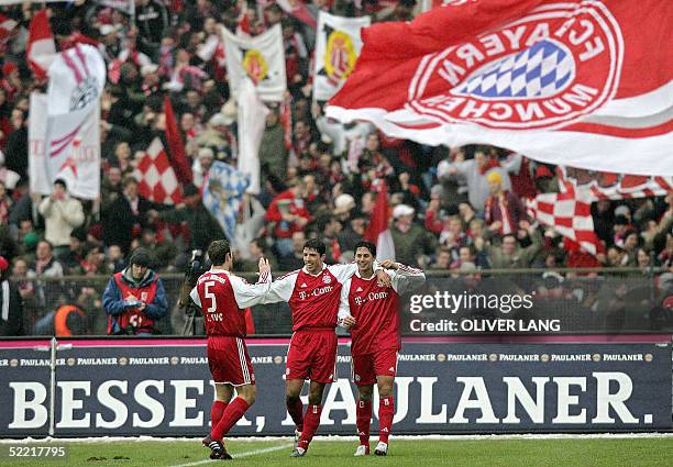 Bayern Munich's players Robert Kovac , Roy Makaay and Claudio Pizarro celebrate their fourth goal against Dortmund 19 February 2005 at Munich's...