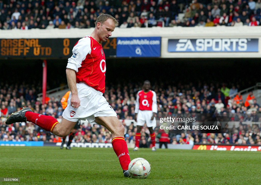 Arsenal's Dennis Bergkamp takes a shot a