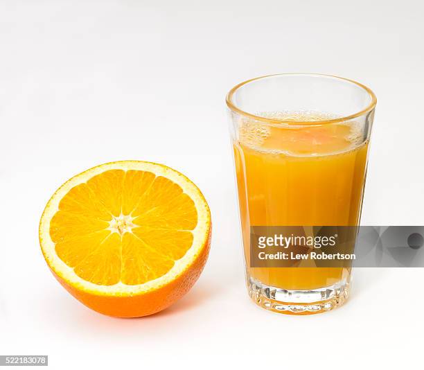 fresh orange juice and orange half - orange juice stock-fotos und bilder