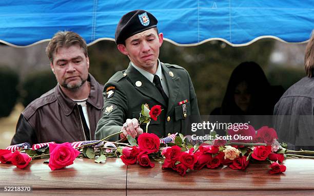 Soldier places a flower on the casket of Sgt. Jessica Housby February 19, 2005 in Rock Island, Illinois. Sgt. Housby, of the Army National Guard's...